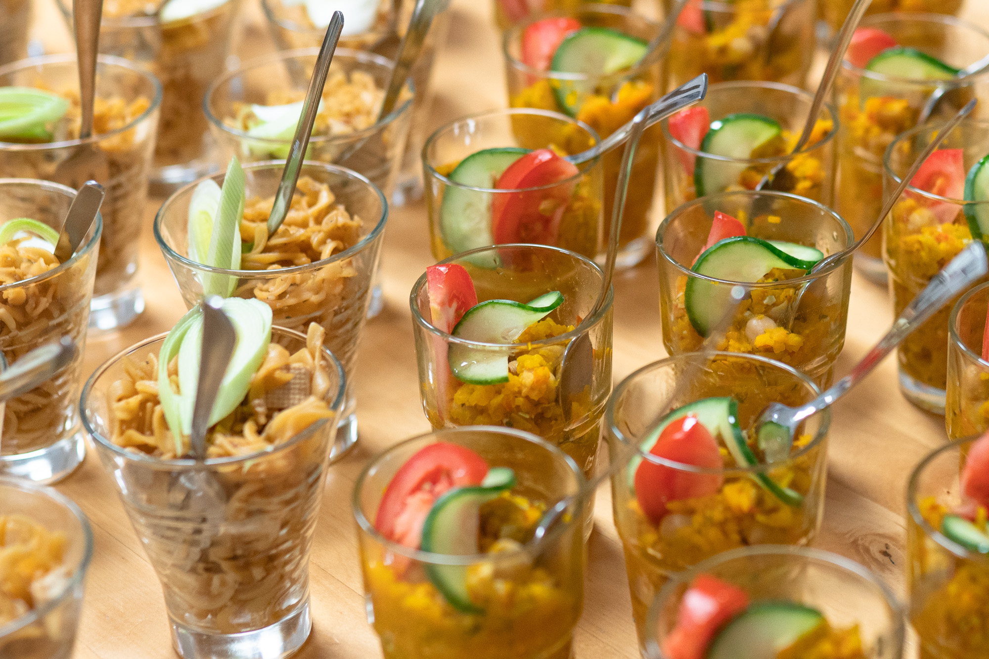 kleine Gläser mit Essen und Löffeln